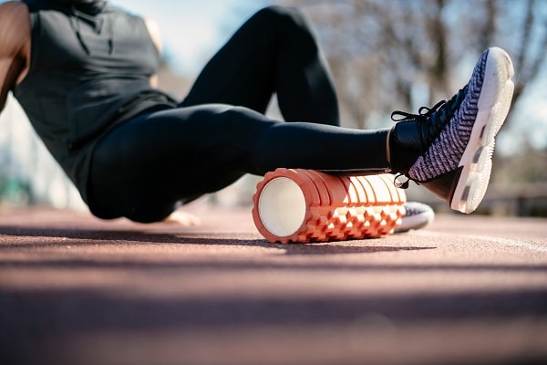Foam rolling calf muscles can help relieve strain on the Achilles tendon